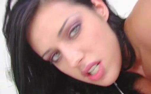 Close view of a dark-haired woman with her mouth open and eyes directed toward the camera.